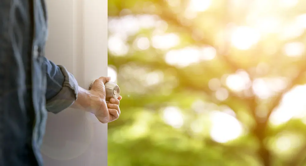 addiction-mental-health-treatment-greenfield-ma Depiction of a man opening door to new life after addiction and mental health treatment