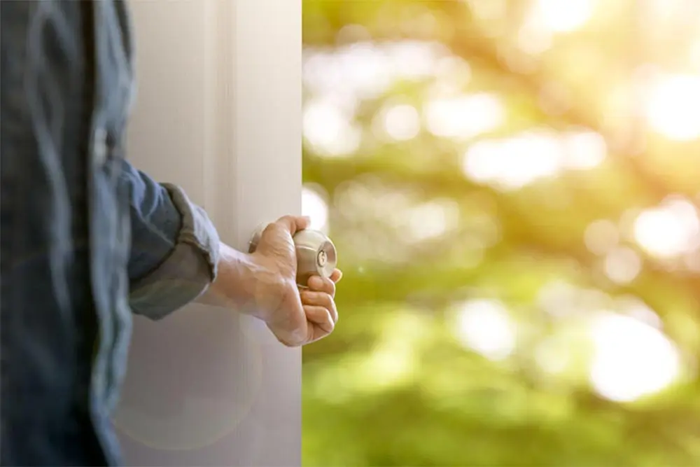 addiction-mental-health-treatment-greenfield Depiction of a man opening door to new life after addiction and mental health treatment